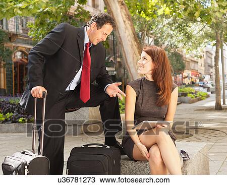 Stock Image - Business people talking outdoors. Fotosearch