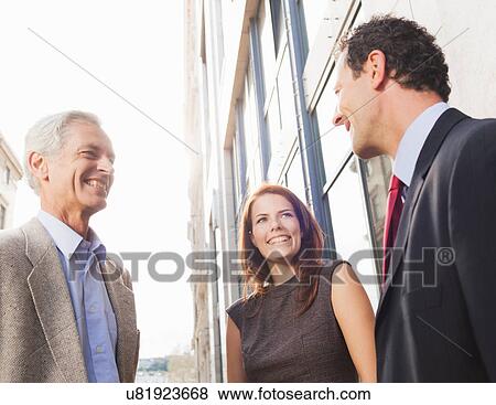 Stock Photo - Business people talking outdoors. Fotosearch