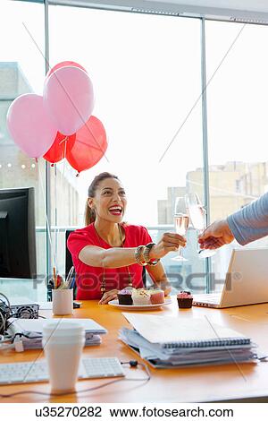 Stock Image - Business people toasting at office party. Fotosearch