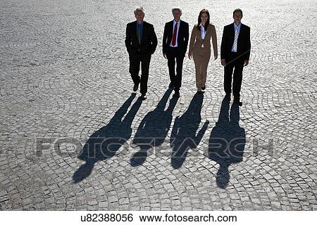 Business people walking on cobbled road View Large Photo Image Stock Photograph - Business people walking on cobbled road. Fotosearch