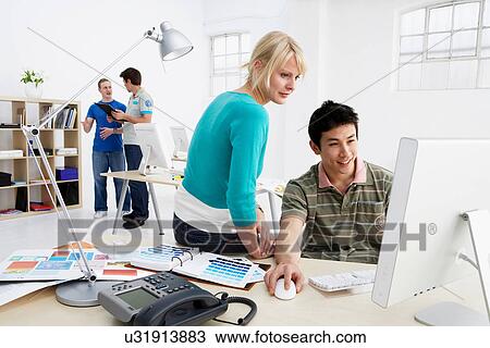 Stock Image - Business people working in office. Fotosearch