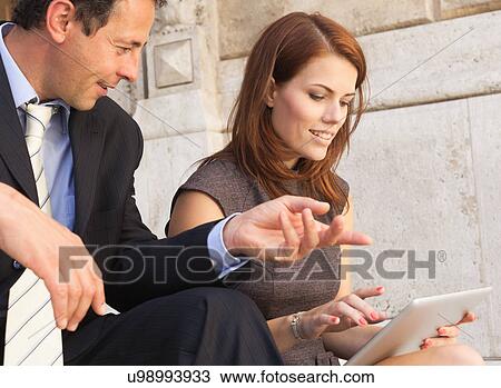 Stock Image - Business people working on stone steps. Fotosearch