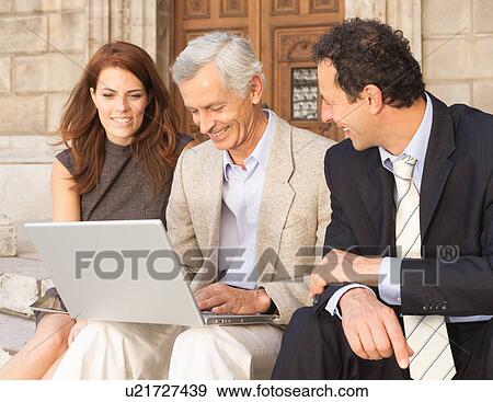 Stock Photo - Business people working on stone steps. Fotosearch