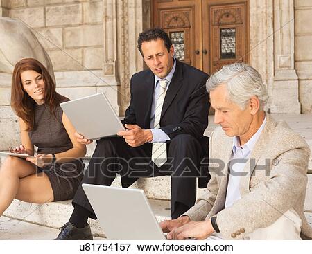 Business people working on stone steps View Large Photo Image Stock Photo - Business people working on stone steps. Fotosearch