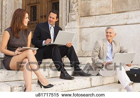Stock Photography - Business people working on stone steps. Fotosearch