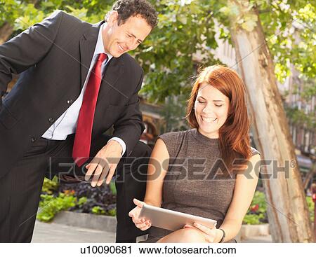 Stock Image - Business people working outdoors. Fotosearch