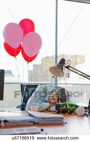 Businessman asleep at desk after party View Large Photo Image Stock Photo - Businessman asleep at desk after party. Fotosearch
