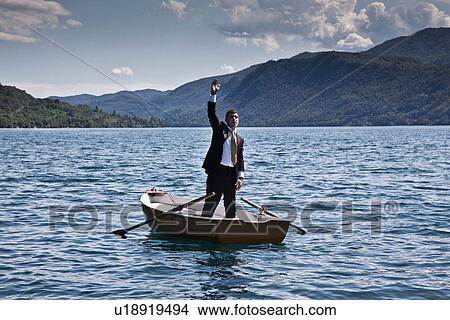 Businessman calling for help in rowboat View Large Photo Image Picture - Businessman calling for help in rowboat. Fotosearch