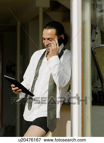 Businessman dressing on cell phone View Large Photo Image Stock Photo - Businessman dressing on cell phone. Fotosearch