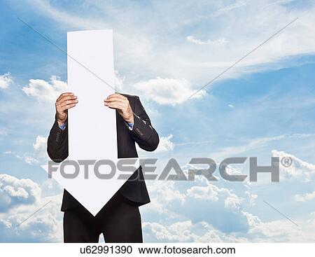 Stock Image - Businessman holding blank arrow. Fotosearch