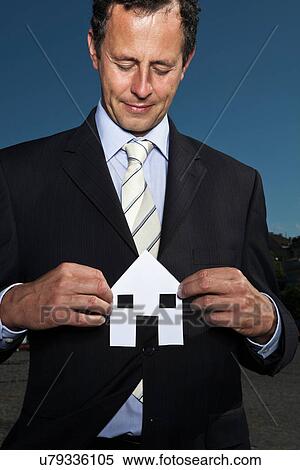 Businessman holding paper house View Large Photo Image Stock Photography - Businessman holding paper house. Fotosearch