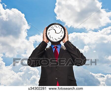 Businessman holding warped clock View Large Photo Image Stock Image - Businessman holding warped clock. Fotosearch