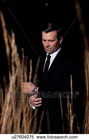 Businessman in wheat field at night View Large Photo Image Stock Photography - Businessman in wheat field at night. Fotosearch