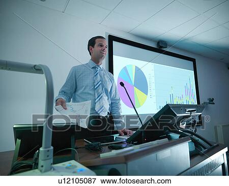 Businessman making presentation on screen in conference room View Large Photo Image Stock Photo - Businessman making presentation on screen in conference room. Fotosearch