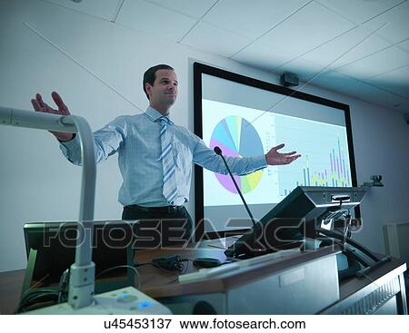 Businessman making presentation on screen in conference room View Large Photo Image Stock Photo - Businessman making presentation on screen in conference room. Fotosearch