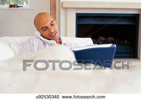Businessman on phone using laptop View Large Photo Image Stock Image - Businessman on phone using laptop. Fotosearch
