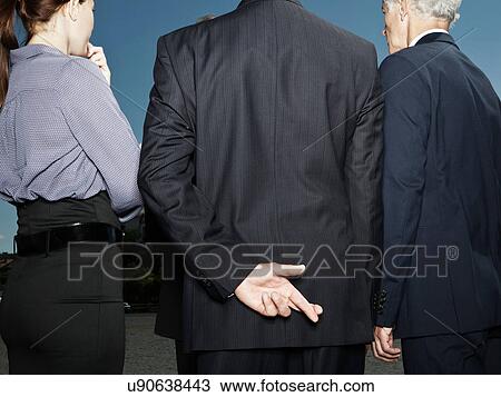 Businessman secretly crossing fingers View Large Photo Image Stock Image - Businessman secretly crossing fingers. Fotosearch