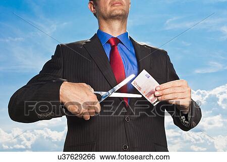 Stock Photograph - Businessman slicing Euro bill. Fotosearch