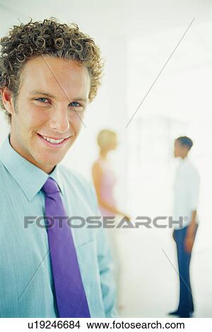 Picture - Businessman smiling in office. Fotosearch
