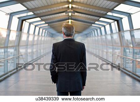 Businessman standing on bridge View Large Photo Image Stock Photo - Businessman standing on bridge. Fotosearch