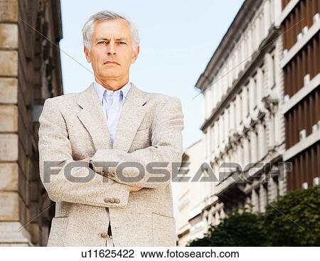 Businessman standing with arms crossed View Large Photo Image Stock Image - Businessman standing with arms crossed. Fotosearch