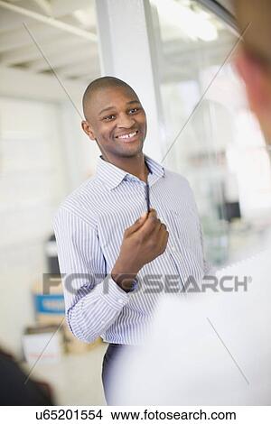 Businessman talking in office View Large Photo Image Picture - Businessman talking in office. Fotosearch