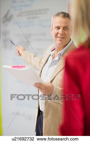 Businessman talking in office View Large Photo Image Stock Image - Businessman talking in office. Fotosearch