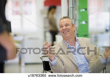 Businessman talking in office View Large Photo Image Stock Photography - Businessman talking in office. Fotosearch
