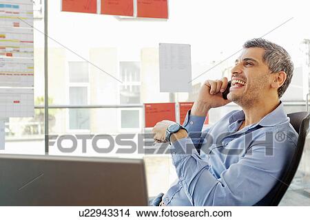 Businessman talking on cell phone View Large Photo Image Picture - Businessman talking on cell phone. Fotosearch