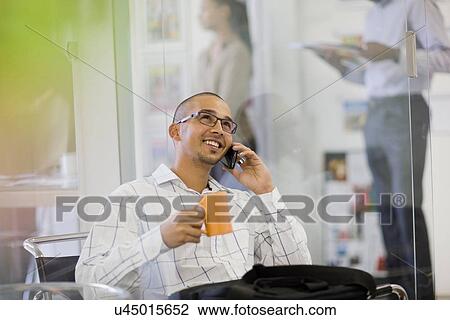Businessman talking on cell phone View Large Photo Image Stock Image - Businessman talking on cell phone. Fotosearch