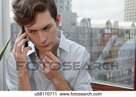 Stock Image - Businessman talking on cell phone. Fotosearch