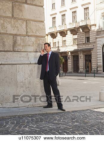 Businessman talking on cell phone View Large Photo Image Stock Photo - Businessman talking on cell phone. Fotosearch