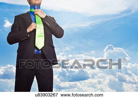 Stock Photo - Businessman tying his tie outdoors. Fotosearch