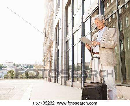 Businessman using tablet computer View Large Photo Image Stock Image - Businessman using tablet computer. Fotosearch