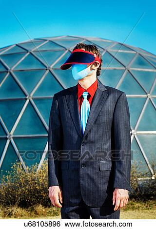 Businessman wearing visor and mask View Large Photo Image Stock Photograph - Businessman wearing visor and mask. Fotosearch