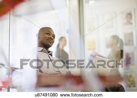 Stock Image - Businessman working on laptop in office. Fotosearch