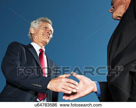 Businessmen shaking hands outdoors View Large Photo Image Stock Photograph - Businessmen shaking hands outdoors. Fotosearch