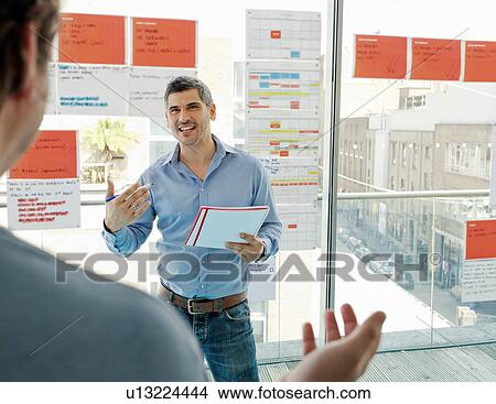 Businessmen talking in office View Large Photo Image Picture - Businessmen talking in office. Fotosearch