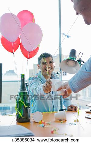 Businessmen toasting at office party View Large Photo Image Picture - Businessmen toasting at office party. Fotosearch