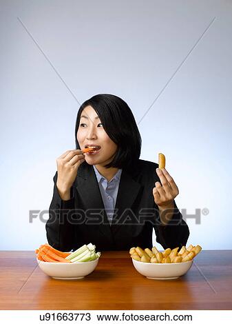 Businesswoman deciding what to eat View Large Photo Image Stock Image - Businesswoman deciding what to eat. Fotosearch