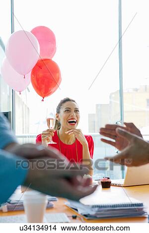 Businesswoman drinking at office party View Large Photo Image Picture - Businesswoman drinking at office party. Fotosearch