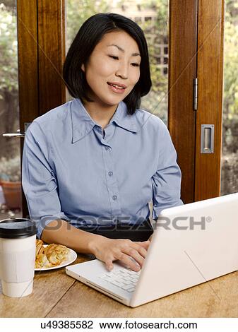 Businesswoman eating and working View Large Photo Image Stock Image - Businesswoman eating and working. Fotosearch