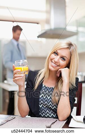 Picture - Businesswoman having breakfast. Fotosearch