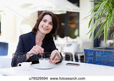 Businesswoman having coffee in cafe View Large Photo Image Picture - Businesswoman having coffee in cafe. Fotosearch