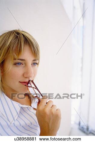 Businesswoman holding glasses to mouth View Large Photo Image Stock Image - Businesswoman holding glasses to mouth. Fotosearch