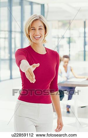 Businesswoman offering hand in greeting View Large Photo Image Stock Image - Businesswoman offering hand in greeting. Fotosearch