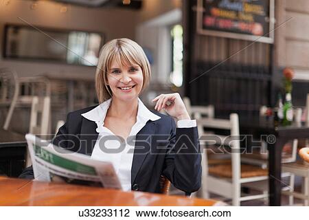 Businesswoman reading in cafe View Large Photo Image Stock Image - Businesswoman reading in cafe. Fotosearch