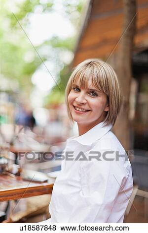Stock Photo - Businesswoman sitting in cafe. Fotosearch