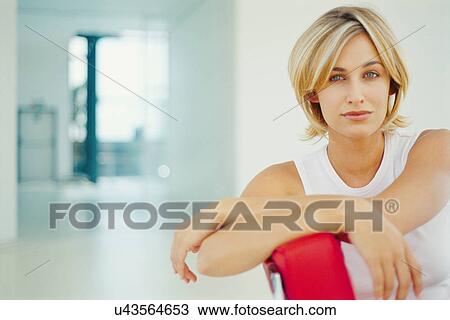 Stock Image - Businesswoman sitting in office chair. Fotosearch