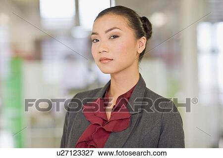 Stock Photo - Businesswoman smiling in office. Fotosearch